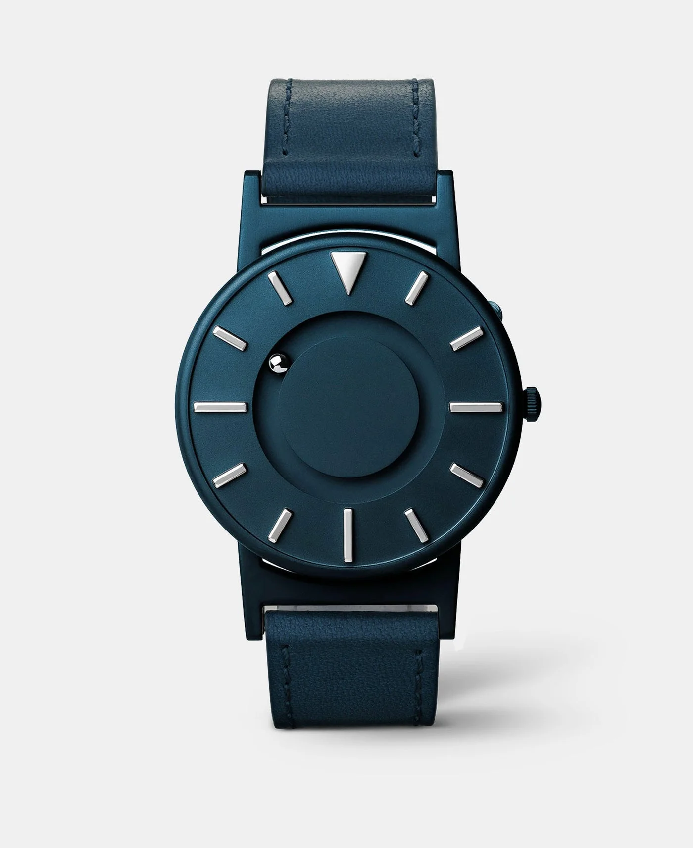 Sleek navy blue watch with tactile markers and magnetic ball bearings for time display.