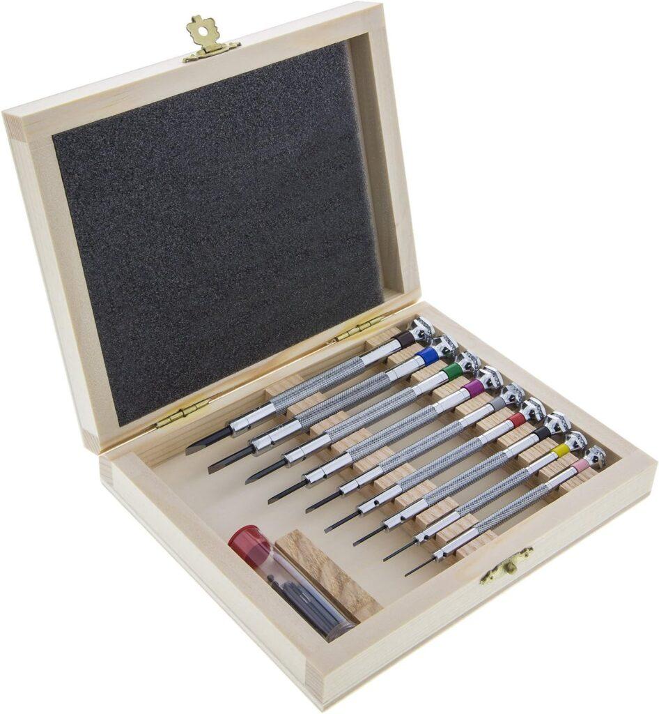 Close-up of a screwdriver set with different sizes neatly arranged in a wooden box.