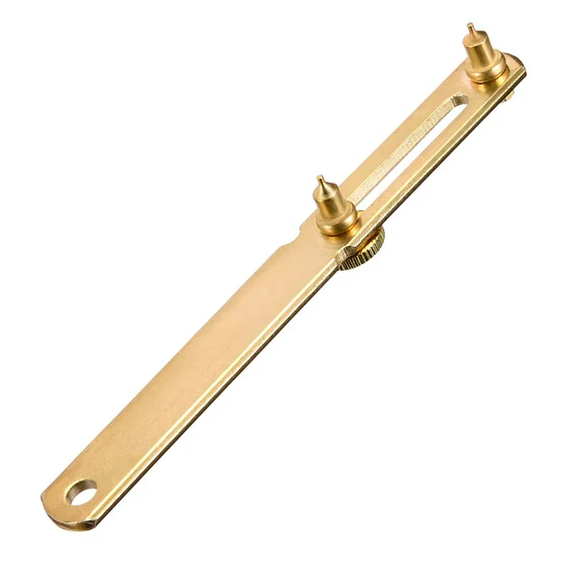 Close-up of the gold-tone watch caseback opener with handle.