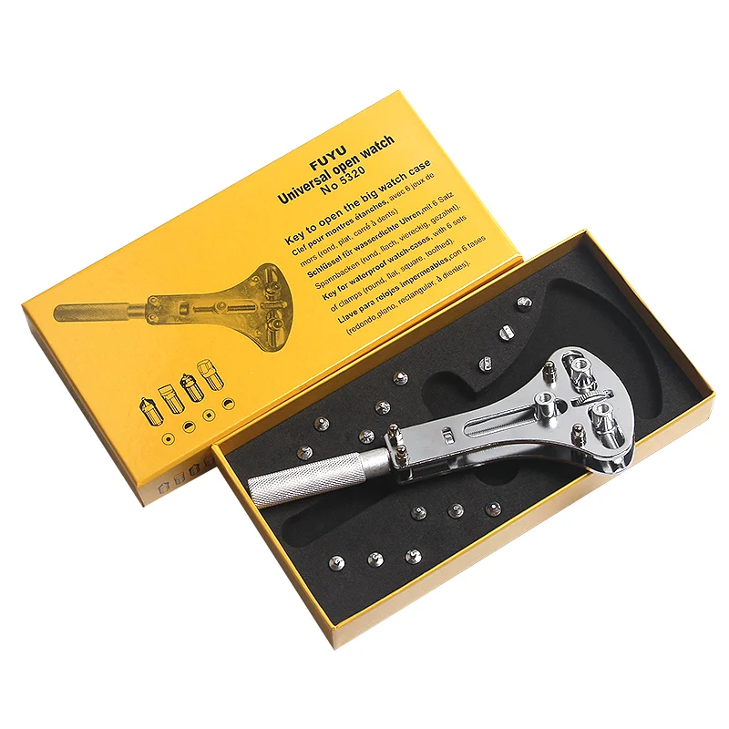 "Close-up of a three-prong watch back opener resting in a box.