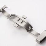 A stainless steel watch butterfly clasp on a white background.