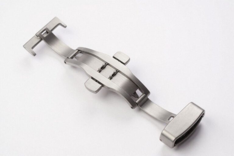 A stainless steel watch butterfly clasp on a white background.