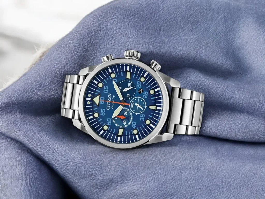 Citizen Avion CA4211-72L resting on wrinkled light blue fabric.