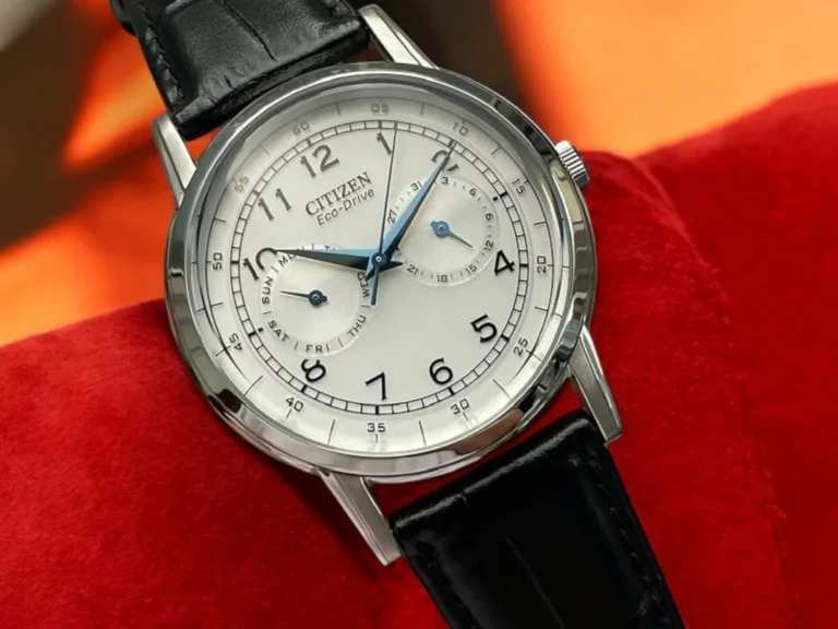 Close-up of the Citizen Classic AO9000-06B with black leather strap resting on a bright red cushion.