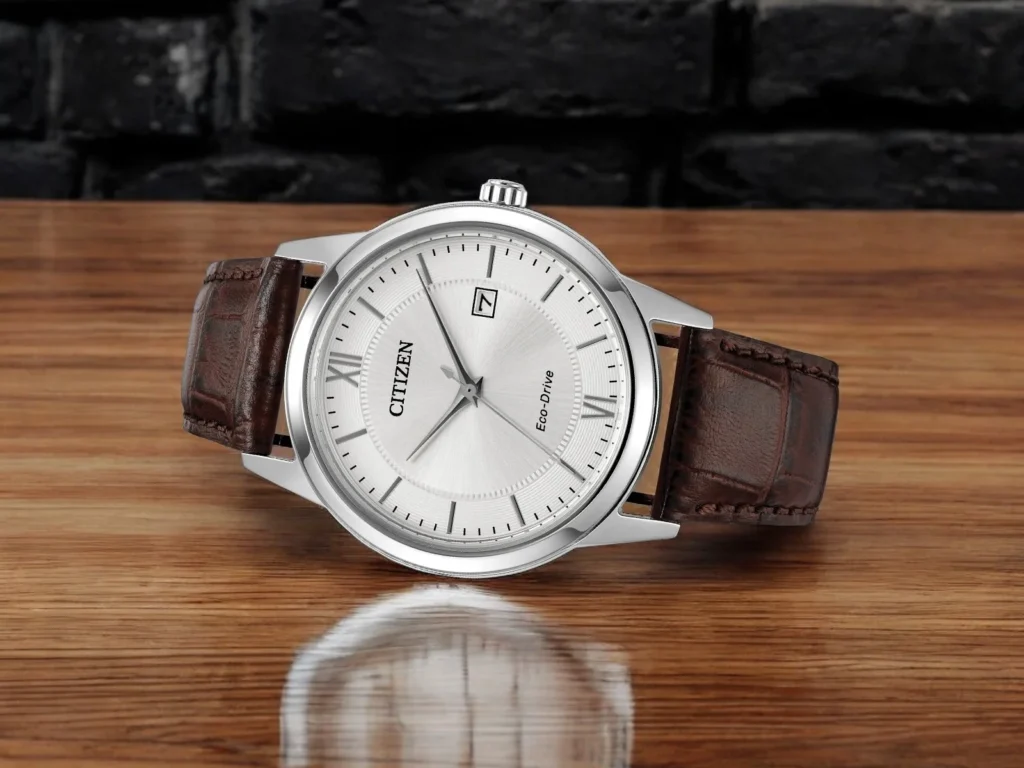 Citizen Classic AW1780-25A is displayed on a wooden surface against a black brick background.