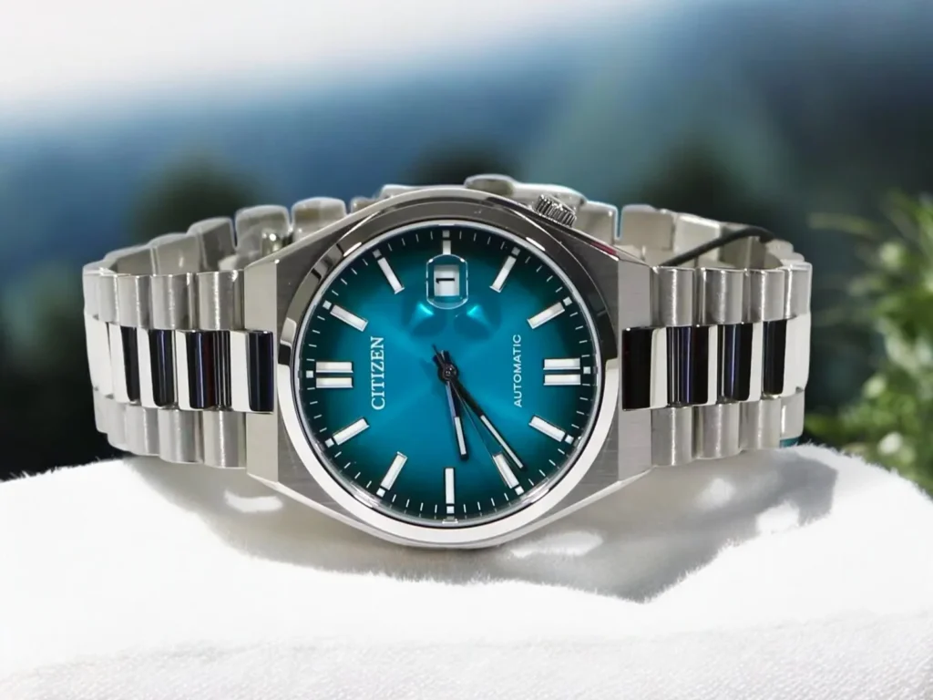 Citizen Tsuyosa Automatic NJ0151-53X resting on a white surface with a blurred outdoor backdrop.