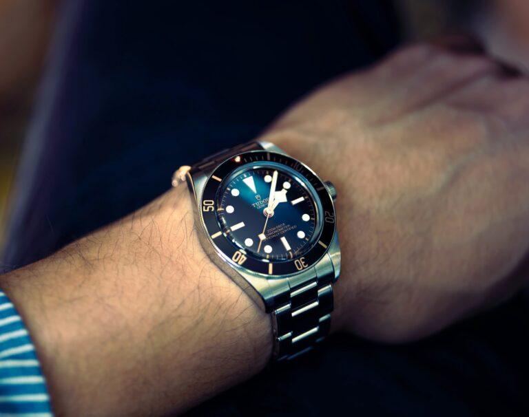 Close-up of a Tudor dive watch on a person's wrist.