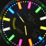 Close-up view of the Ball watch face featuring multi-colored luminescent indices and hands.
