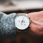 Close-up of a minimalist MVMT watch on a person's wrist