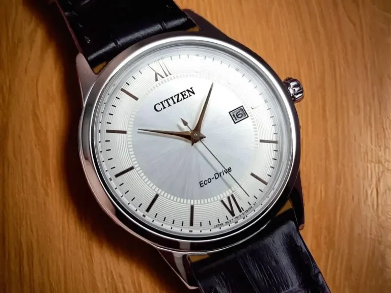 Close-up of the Citizen Corso Eco-Drive AW1236-03A, showcasing its refined silver dial, rose gold-tone hands, and date window.