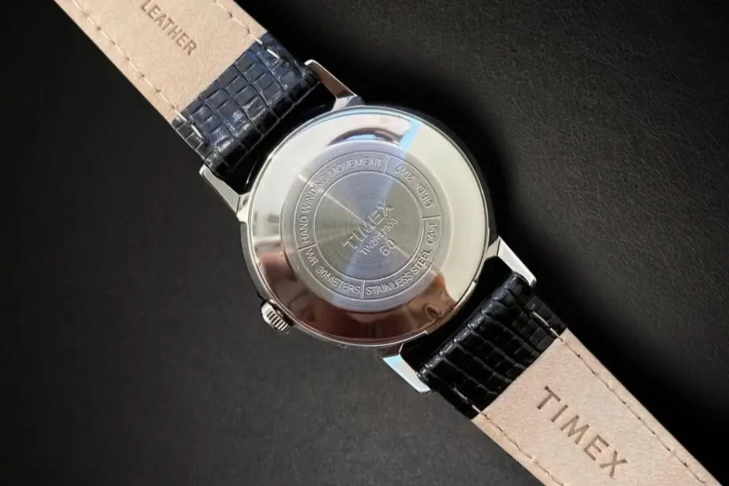 Timex Marlin Hand-Wound TW2R47900 case back on a black leather surface.