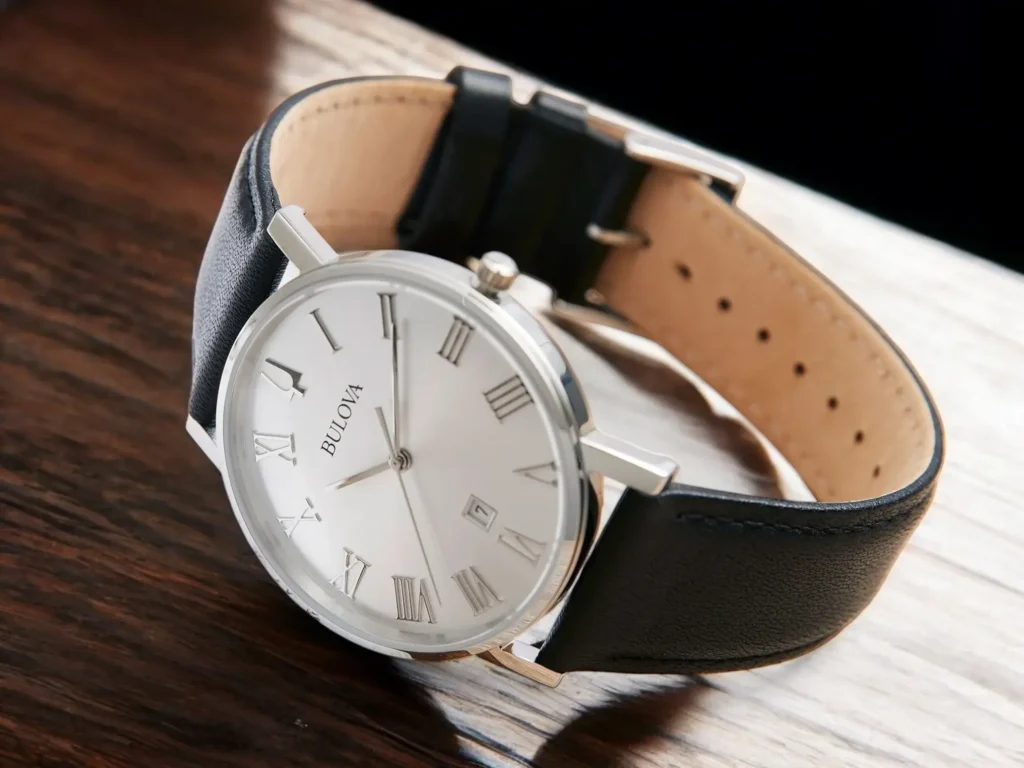 Close-up of the Bulova Classic American Clipper 96B312 dress watch on a light brown wooden surface.
