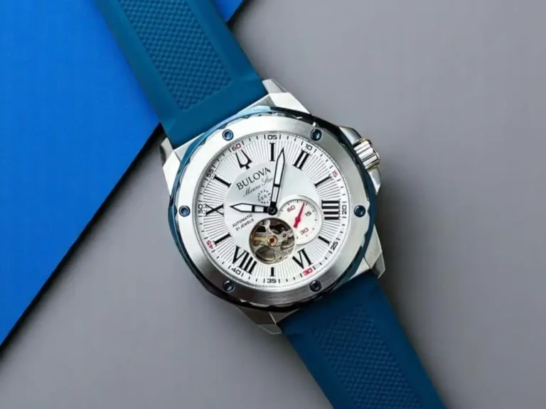 Bulova Marine Star 98A225 with a silver-white dial, photographed against a gray-blue background.