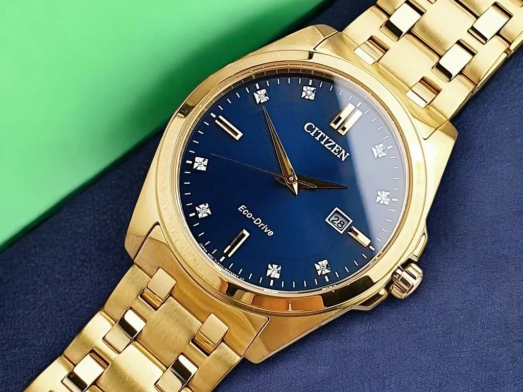 Close-up of the Citizen Peyten BM7103-51L dress watch, displayed against dark fabric and vibrant green background in a refined, minimalist setting.