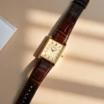 Seiko Essentials SWR064 with brown leather strap on a sunlit beige surface.