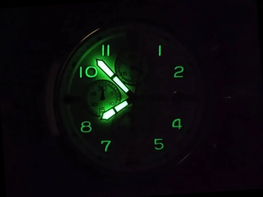 Fossil Dean Chronograph FS4795 watch face with glowing green hands and numbers in the dark.
