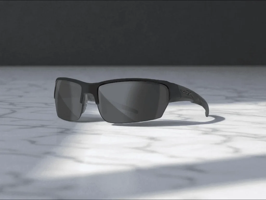 Wiley X WX Saint Polarized sunglasses with dark lenses rest on a sunlit marble surface, casting subtle shadows.