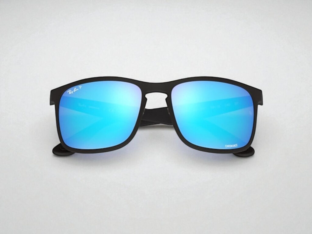 Ray-Ban Chromance Sunglasses with black frames and blue lenses on a light gray background.