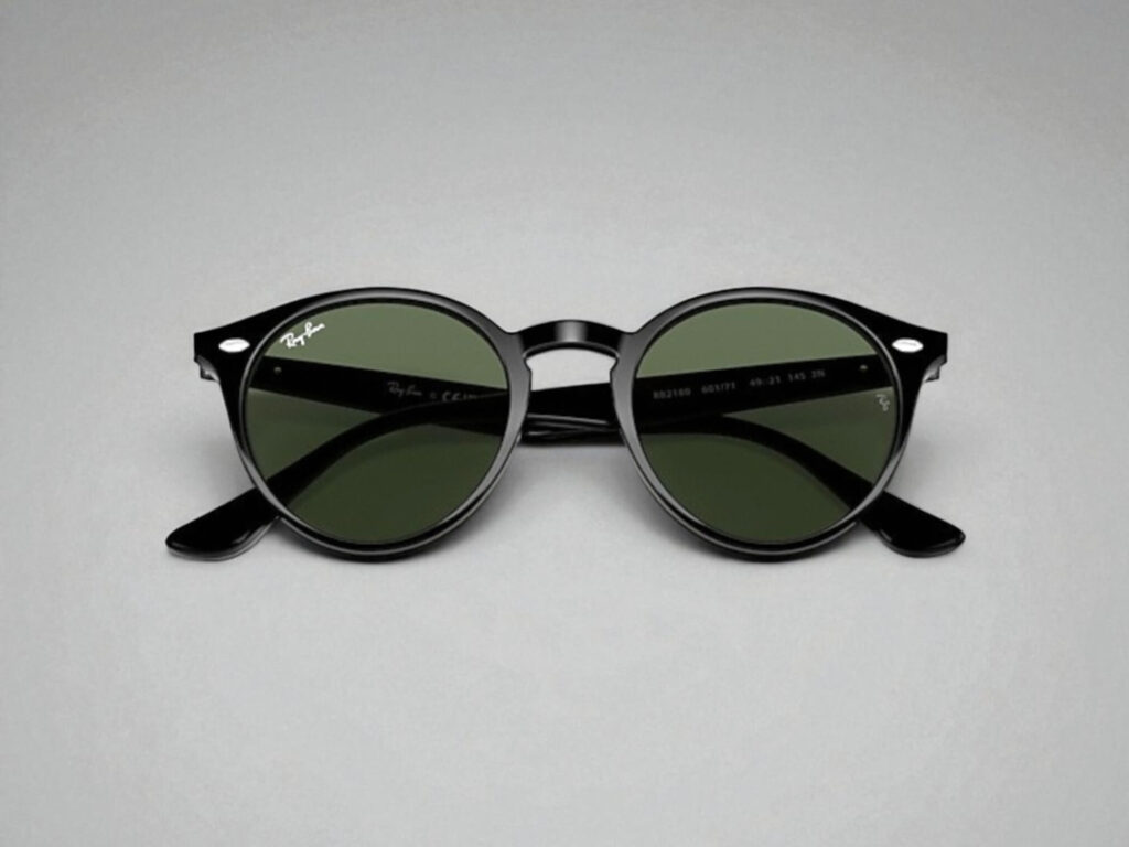 Ray-Ban black round sunglasses with dark green lenses on a gray background.
