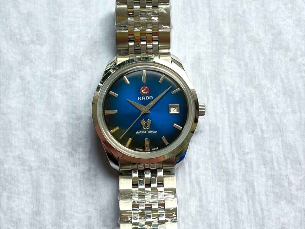 Rado Golden Horse automatic watch with a blue gradient face, displaying the date at 3 o'clock.