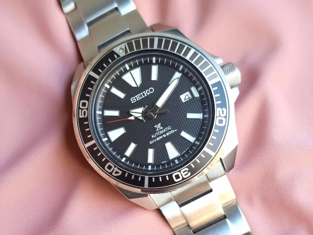 Seiko 5 Automatic Sports SRPD51 resting on pink fabric.