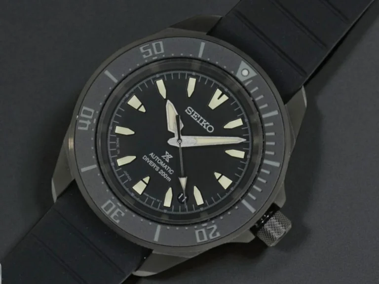 Seiko Prospex Automatic SRPL15 with luminous markers and hands, resting on a black surface.