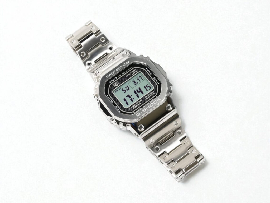 A silver G-Shock GMW-B5000D digital wristwatch with a metal strap on a plain white background.