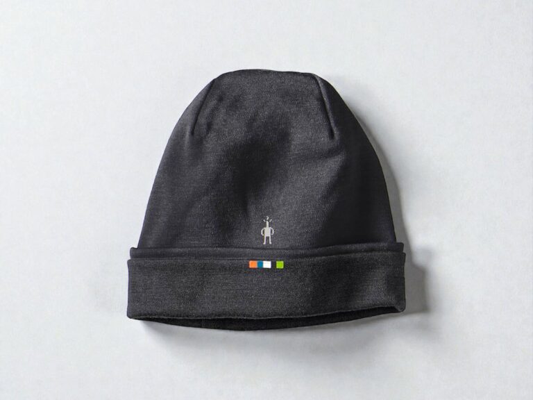 Dark gray Smartwool knit beanie with a small, abstract stick figure logo and a line of colored squares—orange, blue, and green—on the folded brim.