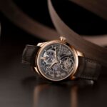 H. Moser & Cie. Endeavour Tourbillon luxurious skeleton watch with a gold case and intricate mechanical movements is displayed against a dark background.