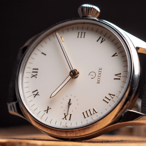 Close-up of a vintage-style watch with an onion-shaped crown.